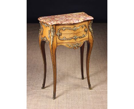 A Fine Quality Louis XV Style Petite Commode with ormolu mounts.  The bêche-d'alep marble top having a moulded edge above two