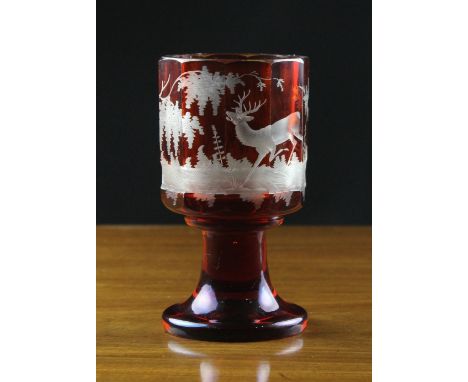 A Late 19th Century Bohemian Ruby Flashed Goblet  The facet-cut sides engraved with a stag in continuous landscape on a flare