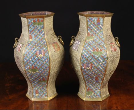 A Pair of Decorative 19th Century Cloisonné Vases. The hexagonal baluster bodies ornamented with alternate panels of scrollwo