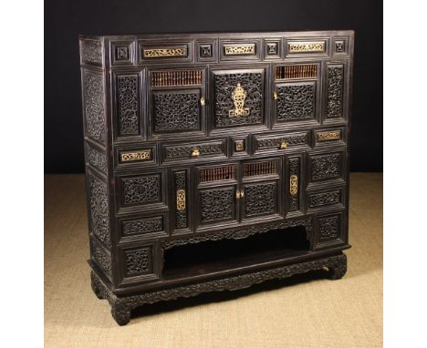 A Rare 19th Century Chinese Carved Ebony and Bone Cabinet housing two frieze drawers between upper and lower twin doored cupb