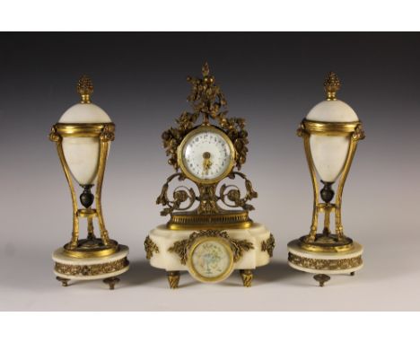 A Pretty 19th Century Louis XVI Style Ormolu Mounted Mantel Clock and a pair of similar Garnitures. The clock having a painte