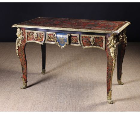 A Fine Régence Style Bureau Plat in the manner of André-Charles Boulle, inlaid all over with intricate brass embellishments o
