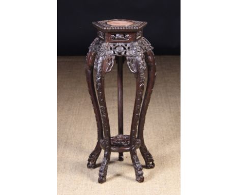 A Chinese Carved Hardwood Stand.  The pentagonal top with round marble inset in a border of flowers with beaded edge. The pie