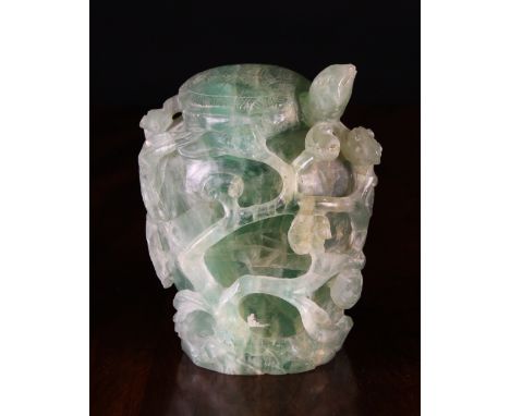 A Jade like Carving of a Tortoise raised on a clump entwined with scrolling stems of leaves, 6½ ins (16.5 cms) in height.