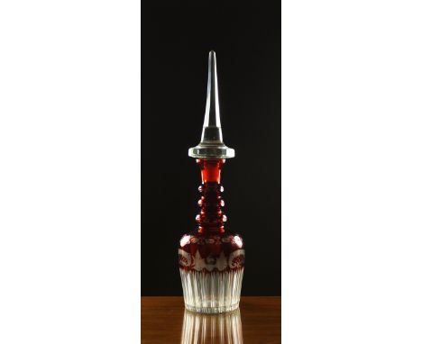 A Large Bohemian Ruby Flashed Glass Decanter.  The large hexagonal clear glass stopper with spire finial. The decanter having