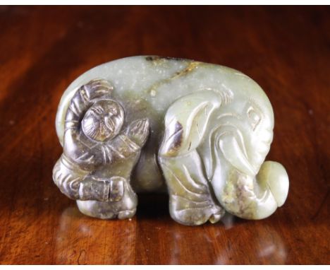 A Jade Carving: Buddhist Imagory of a boy washing an elephant, 2¼ ins (6 cms) high, 3½ ins (9 cms) in length.