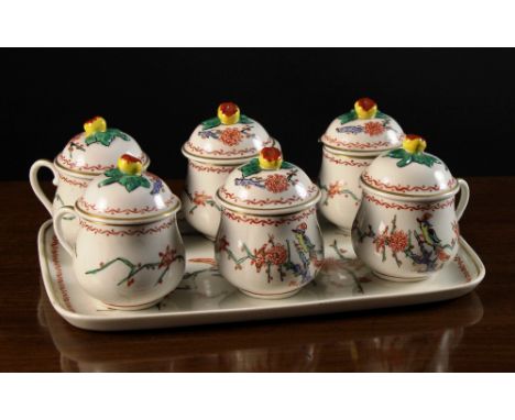 A Set of Six Small Samson Porcelain Lidded Cups on a rectangular tray. The bulbous cups having domed lids surmounted by flora