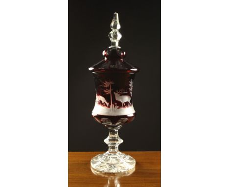 A Bohemian Overlaid Ruby Glass Vase & Cover. The facet cut lid having an hexagonal knopped clear glass finial. The bell shape