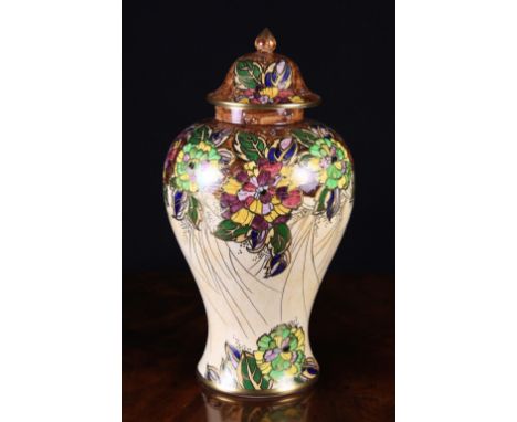 A Royal Winton Lustre Glazed Baluster vase with bell shaped cover surmounted by a pointed finial knop. The piece decorated wi