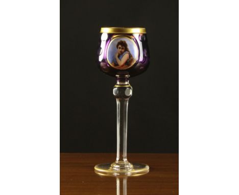 A Bohemian Hock Goblet. The amethyst flashed bowl with a gilt rim band above a painted portrait roundel depicting a lady. The
