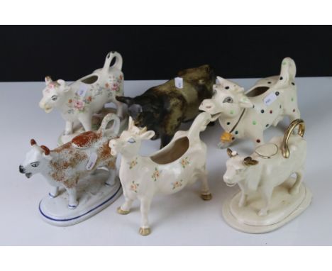 Five Ceramic Cow Creamers including Beswick and 19th century together with a Studio Pottery Bull 