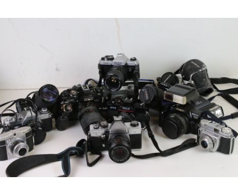 A collection of cameras and lenses to include a Canon AV-1 35mm camera, Minolta Dynax 3000i and a Minolta X-700. 