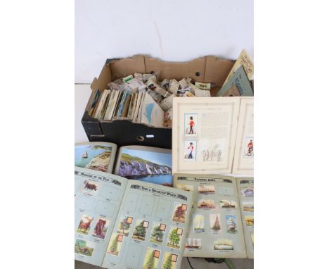 A large collection of mixed cigarette and tea cards within albums together with loose examples. 