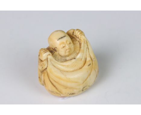 An antique carved ivory netsuke 