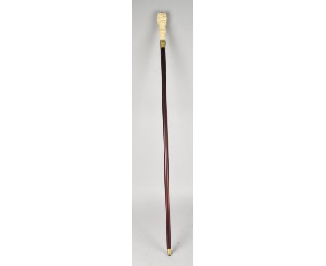 A Bone Effect Handled Walking Stick in the Form of a Clenched Fist Holding Serpent, 97.5cms Long