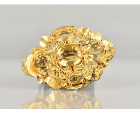 A Large Victorian Citrine and Filigree Gold Metal Brooch, Testing 14-18ct, Central Oval Cut Stone 14.3 by 11.4mm with Scrolli