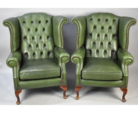 A Pair of Green Leather Button Upholstered Wing Armchairs