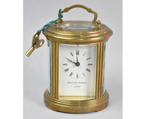 A Mid 20th Century Oval Brass Cased Carriage Clock, White Enamel Dial Inscribed for Matthew Norman, London, Movement in need 