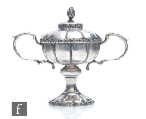 A hallmarked silver novelty miniature twin handled trophy cup and cover with daisy head details to borders, weight 70g, heigh