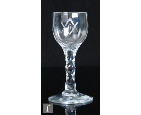 An 18th Century Masonic drinking glass, the ovoid bowl engraved with a letter G within the square and compass above a hollow 