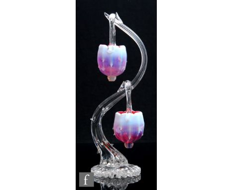 A late 19th Century Stourbridge posy stand, the clear crystal rustic form stand of S form with two sunrise opal hanging baske