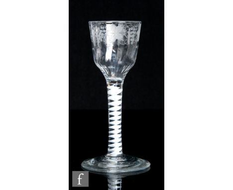 An 18th Century drinking glass, circa 1765, with a fluted ogee bowl engraved with leaves and berries, over a single series op