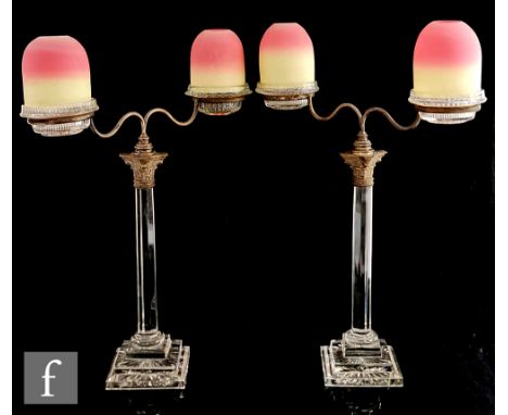 A pair of 19th Century Clarke's Cricklite twin arm candelabra, the Clarke's Fairy Night Light pressed glass bases with Thomas