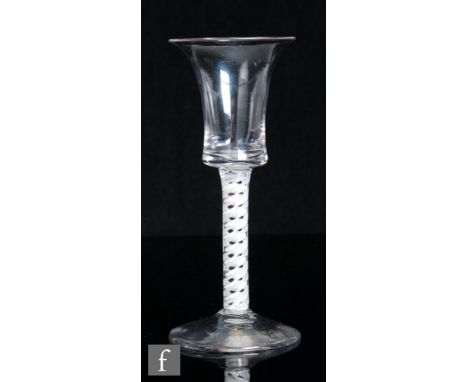 An 18th Century drinking glass, circa 1770, the waisted bucket bowl above a double series opaque twist stem with a gauze outs