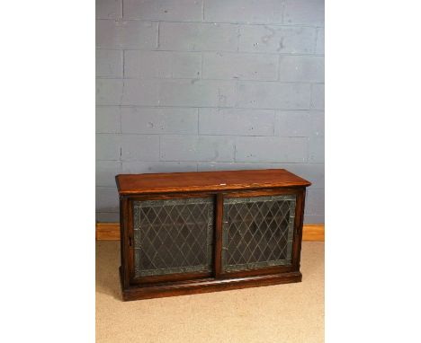 20th century oak and leaded glazed side cabinet, the rectangular top above a pair of sliding leaded glazed doors enclosing a 