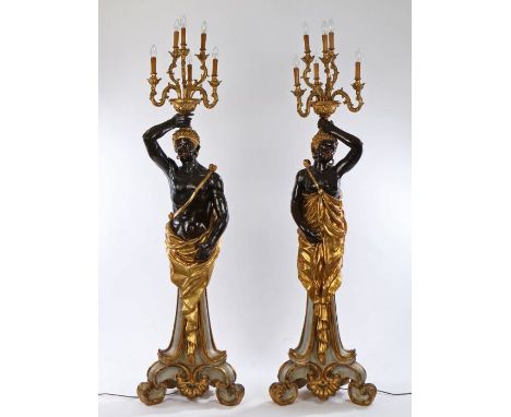Pair of Venetian style Blackamoor candelabras, the standing male and female figures holding aloft the light fittings, wearing