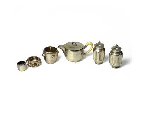 A unusual matching silver drinking set including a silver teapot with an ivory handle standing on four feet, a pair of canist