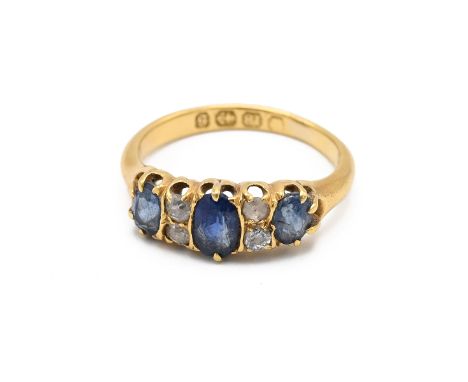 A Victorian 18ct gold, diamond and sapphire ring, set with three oval sapphires and four old cut diamond, Birmingham 1892, fi