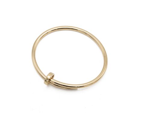 Cartier - An 18ct yellow gold 'Juste un Clou' hinged bangle, signed Cartier, numbered '18 HRE182', internal dimensions 58x50m