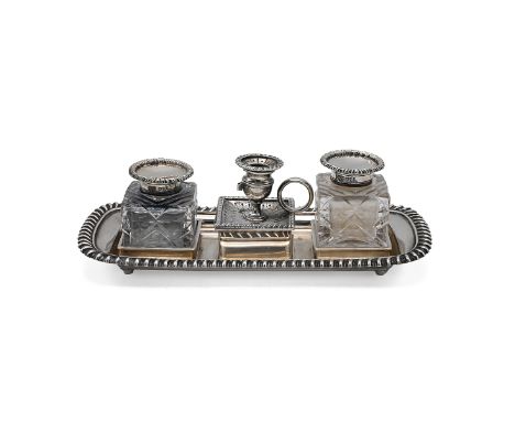 A silver Victorian inkwell, with a detachable chamberstick, gadroon border, London 1878, and two later detachable silver and 