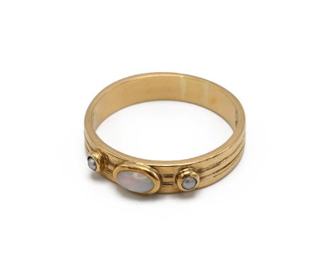 An 18ct yellow gold opal and seed pearl three stone ring, the rub over set stones on a 4.3mm reeded band, ring size Q, maker'