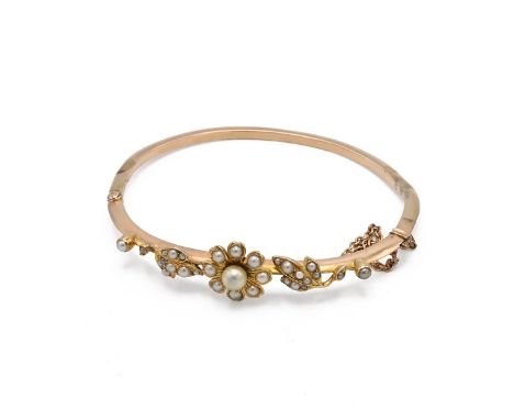 A 20th century gold cultured and seed pearl bangle, with flower head bud and leaves, 11.94 grams. Tested as 14ct gold. (J)&nb