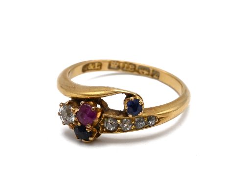 A late Victorian 18ct yellow gold gem set ring, modelled as a stylised snake, set with old cut diamonds, sapphires and a ruby