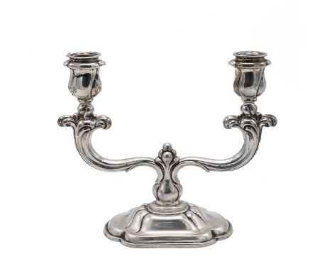 A continental silver two section candlestick, of stylised form, 20cm high, stamped "830", 462 grams weighted.