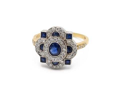 An 18ct yellow gold, diamond and sapphire Art Deco style cocktail ring, set with a central sapphire surrounded by eight small