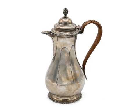 A George V silver coffee pot, of baluster form, flame finial and shaped handle, standing on circular base, London 1927, F. B.