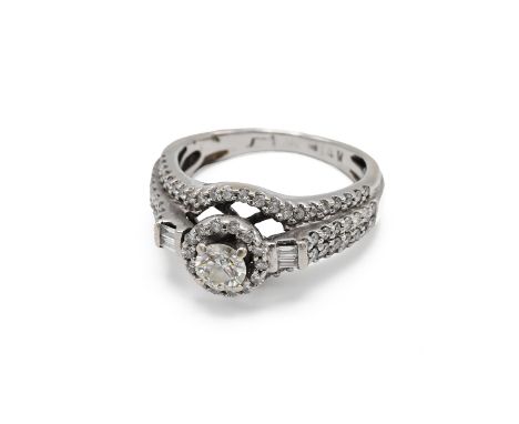 A 14k white gold and diamond dress ring, set with a round brilliant cut diamond approximately 0.3ct, further smaller pav&eacu