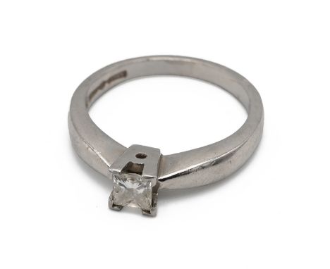 An 18ct white gold and diamond ring, in a four claw setting, the princess cut stone weighing approximately 0.33 carats, finge