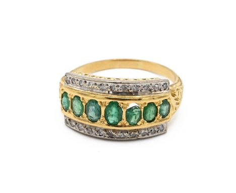 A gold, emerald and diamond set cluster ring, the centre set with six ovals emeralds, surrounded by a pave diamond setting, f