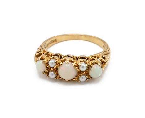 An 18ct gold, seed pearl and opal Victorian style ring, set with three opals and four seed pearls, finger size N, 3.15 grams.