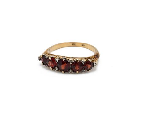 A Victorian 18ct yellow gold garnet seven stone ring, with rose cut diamond accents, ring size O1/2, total gross weight appro