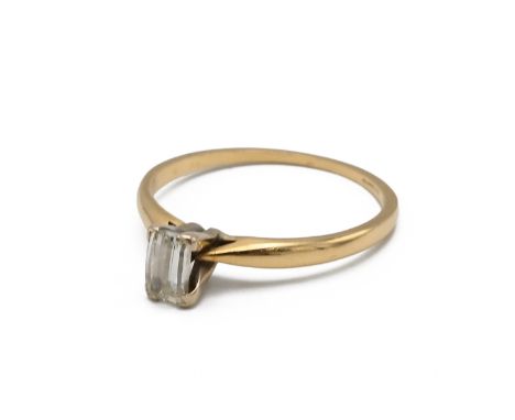 An 18k yellow gold and diamond solitaire ring, set with a rectangular fancy cut diamond, approximately 5.35mm x 3.47mm, ring 