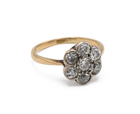 An 18ct yellow gold and diamond flowerhead cluster ring, set with seven old cut diamonds in claw and rub over settings, ring 