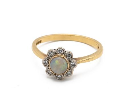 An 18ct gold and opal cluster ring, the central cabochon opal surrounded by eight brilliant cut diamonds, finger size N, 2.68