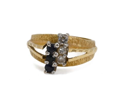 An 18ct gold sapphire and diamond Ring, set with three diamonds and three sapphires each connected in a vertical line, on tex