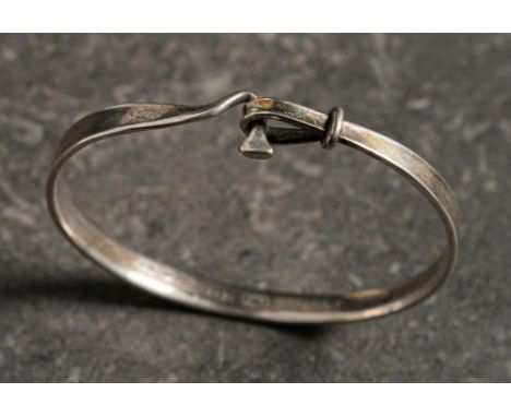 Georg Jensen. A silver bangle of hook and eye design, number 204: stamped 'TORUN' designed by Vivianna Torun, approximately 1